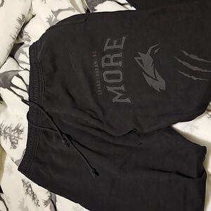 ALPHALETE Black Sweatpants with leg design.